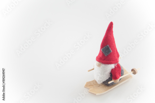 Santa Claus puppet on skis, wood wool
