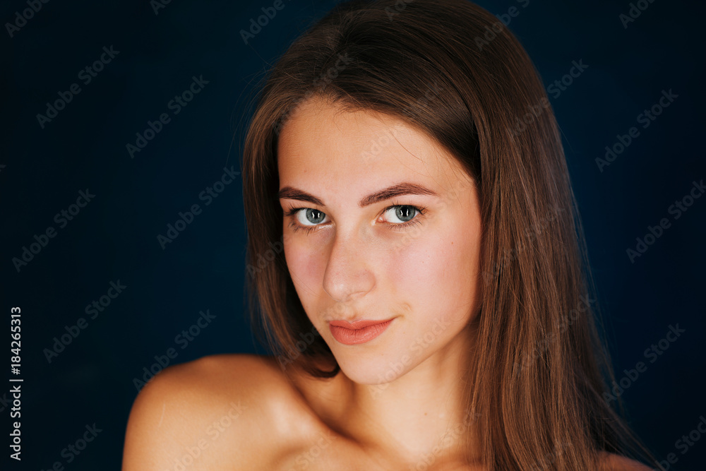 Portrait beautiful girl on a dark studio background