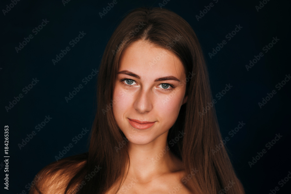 Portrait beautiful girl on a dark studio background Portrait beautiful girl on a dark studio background