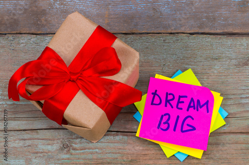 dream big and gift box concept - motivational advice or reminder on colorful sticky notes