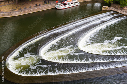 Cascading water current on River Avon, Bath, Engand photo
