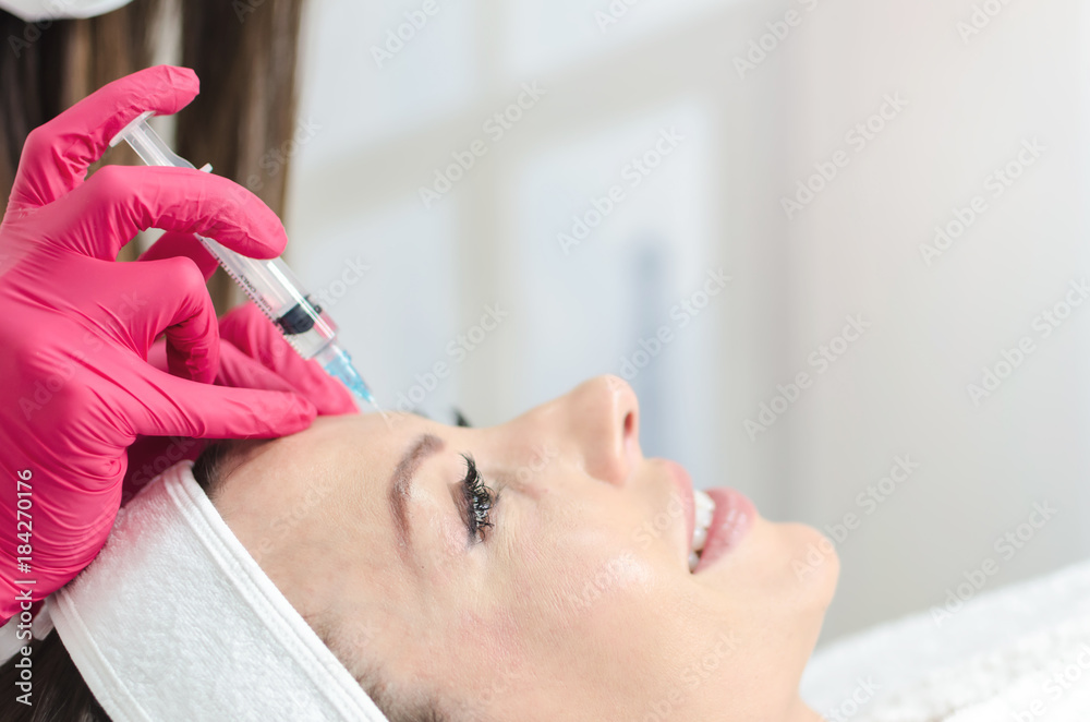 Serene female receiving collagen injection Serene female receiving collagen injection