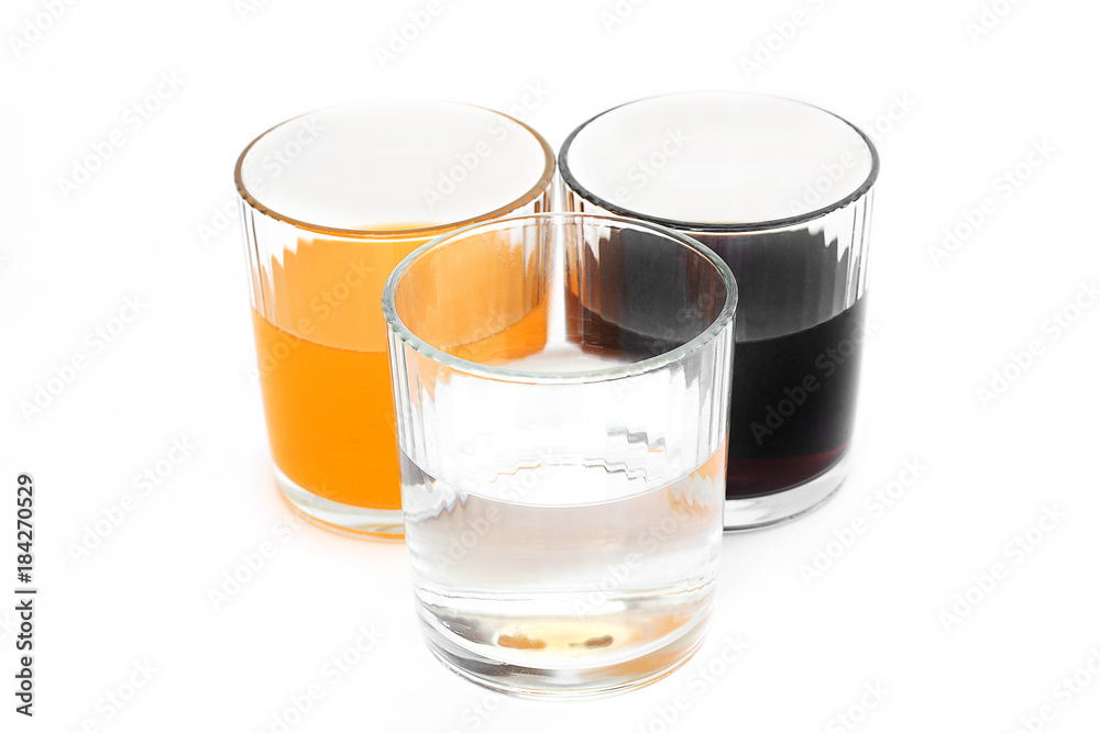 Different drinks in three glasses. Water in a glass on a white background. Drink. Glass