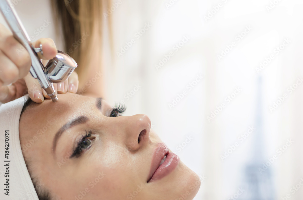 Fototapeta premium Woman have oxygen epidermal skin face treatment, Paris in background