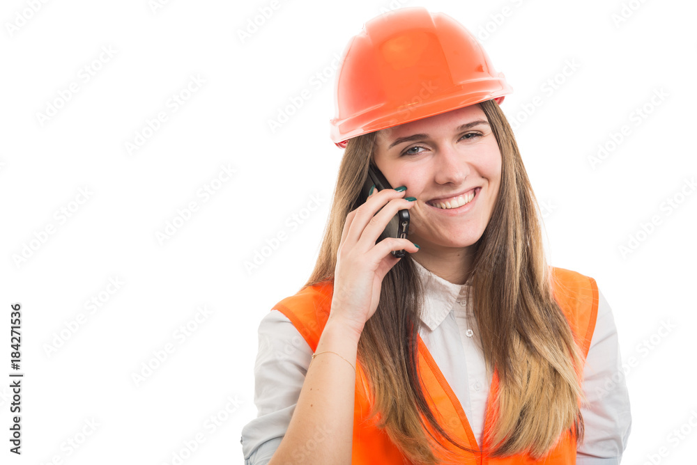 Smiling girl builder talking on the mobile phone Smiling girl builder talking on the mobile phone