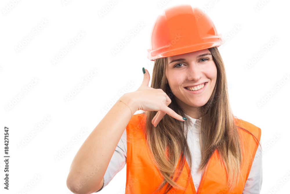 Young happy constructor woman gesturing call me Young happy constructor woman gesturing call me