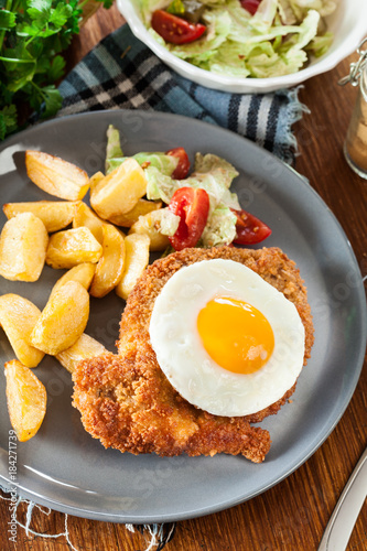 Breaded viennese schnitzel with fried agg