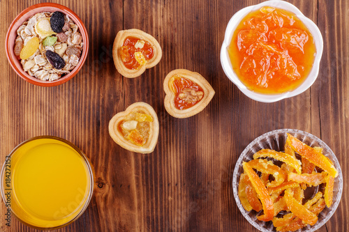 Healthy breakfast. Ceramic bowl with oat flakes  dried fruits  nuts on wood background