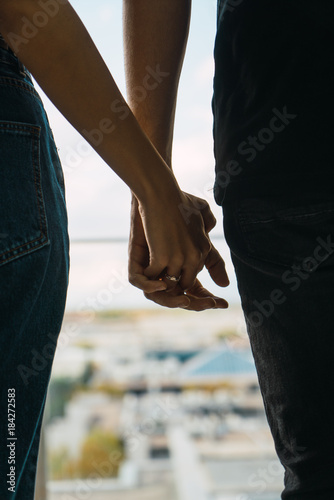 Couple standing and holding hands