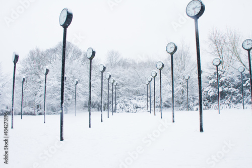 Clocks standing in a snow covered park in the centre of the town of Düsseldorf
