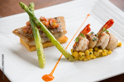 Quadro su tela haute cuisine Pan fried fish fillet of barramundi with shrimps