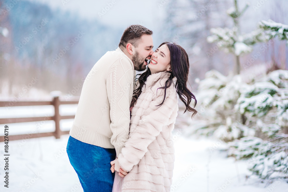 young couple on a walk in the snowy mountains young couple on a walk in the snowy mountains