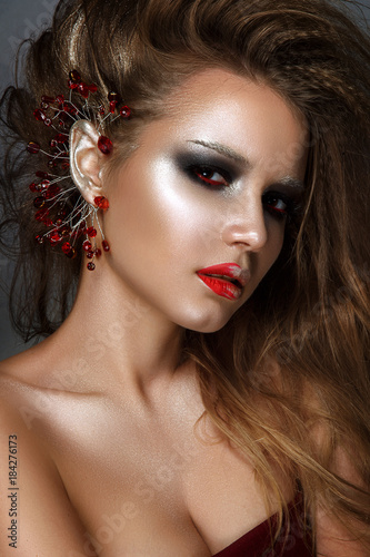 Beautiful woman portrait with red and black make up in rock style.