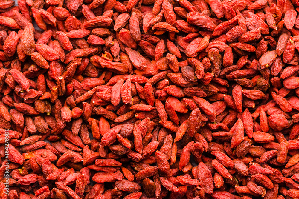 Red background of goji berry, texture of natural dried fruit background with superfood, healthy food ingredient of chinese medicine