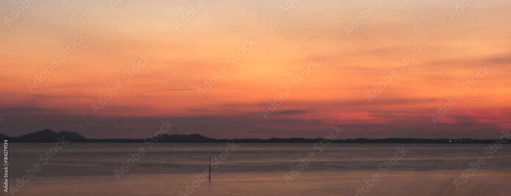 Sea and sunset on background