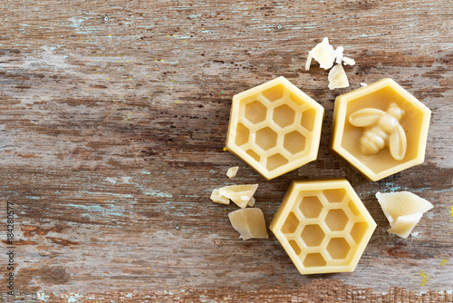 natural yellow beeswax on wooden background. photo