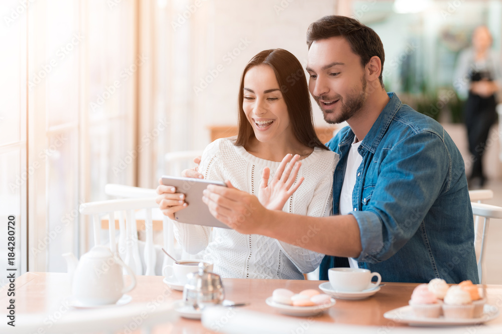 A guy and a girl are sitting together in a cafe. A guy and a girl are sitting together in a cafe.