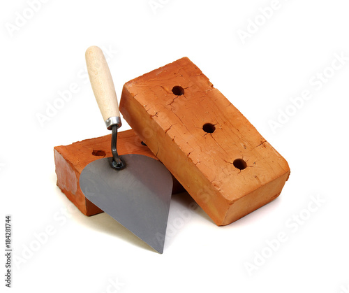 Brick and trowel on a white