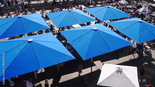 Square blue umbrellas above a cafe