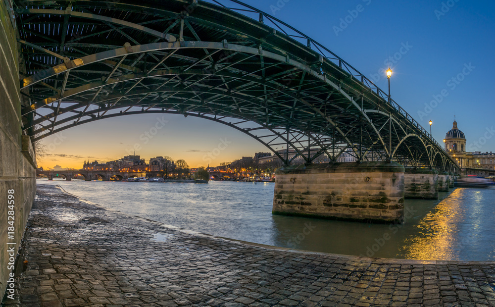 River Seine with Pont des Arts and Institut de France at sunrise in Paris