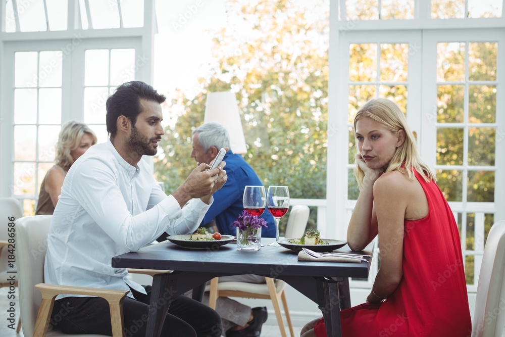 Man ignoring bored woman Man ignoring bored woman