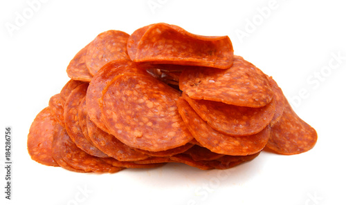 lices of pepperoni on white background