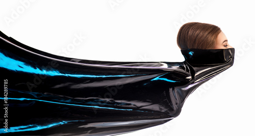 Woman in latex dress on the white background photo