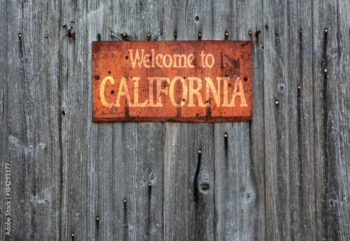 Rusty metal sign with the phrase: Welcome to California.