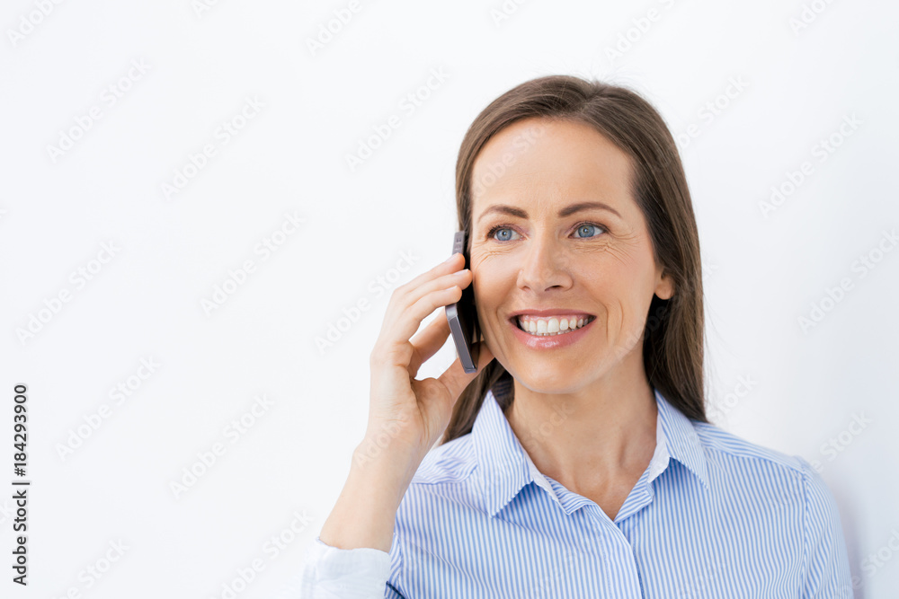 businesswoman calling on smartphone at office businesswoman calling on smartphone at office