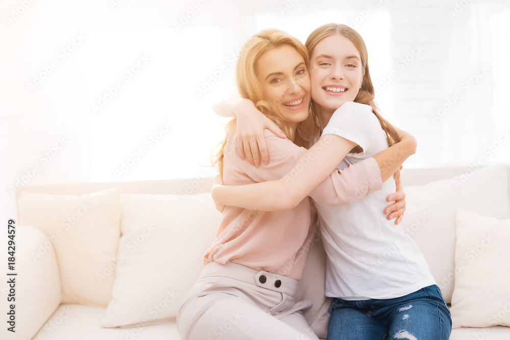 Mom and teenage daughter embrace. Mom and teenage daughter embrace.