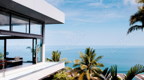 Living room in the modern villa with sea view, shot from outside photo