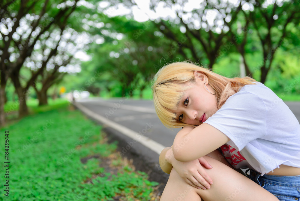 Portrait of asian young girl sit at tunnel trees,Beautiful thai woman take a photo outdoors,sad woman concept,she think over from love,heartbroken from boyfriend Portrait of asian young girl sit at tunnel trees,Beautiful thai woman take a photo outdoors,sad woman concept,she think over from love,heartbroken from boyfriend