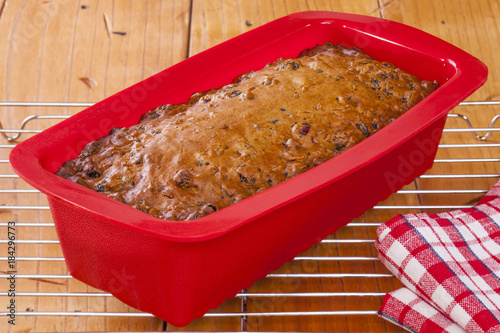 Slika na platnu Freshly baked fruit loaf in silicone bakeware