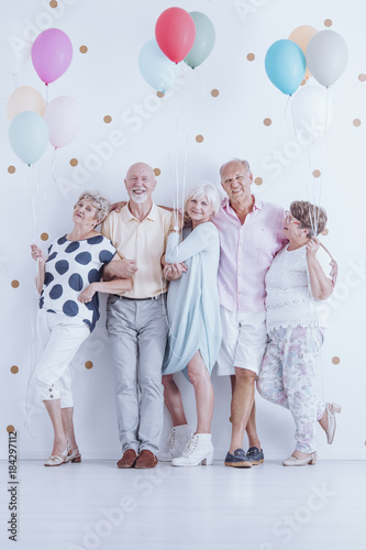 Senior friends with colorful balloons