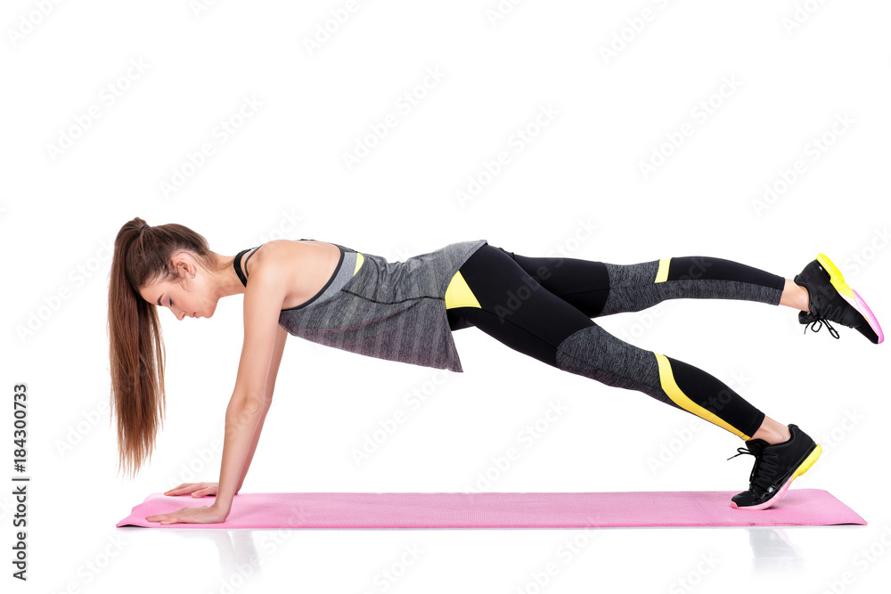 woman in sportswear does exercises on fitness Mat woman in sportswear does exercises on fitness Mat