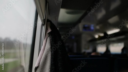 View inside of the fast train with passengers. Daylight, indoor.