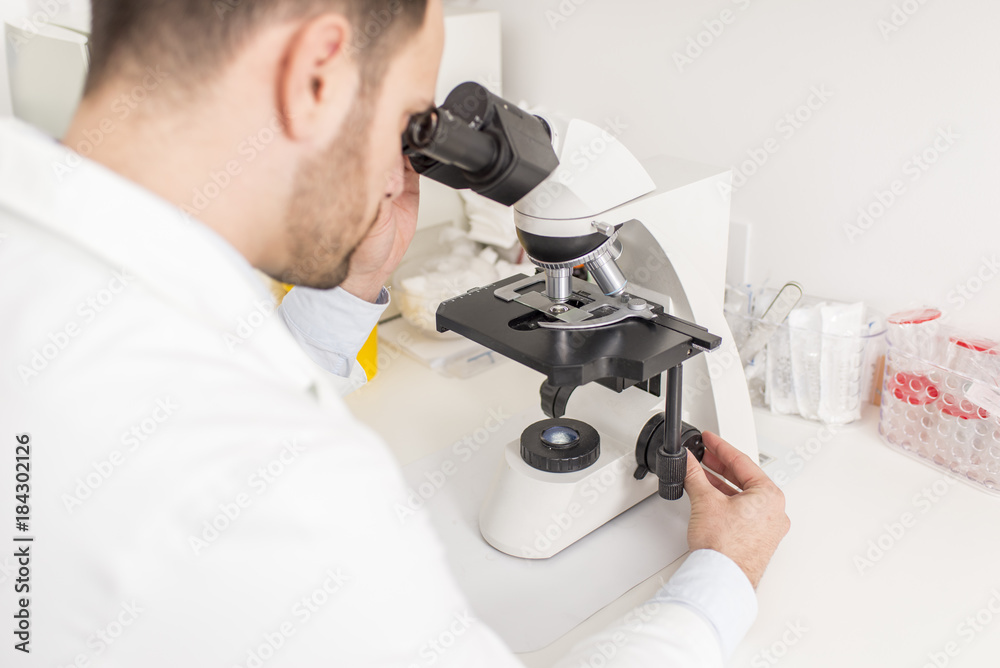 Doctor looks through the microscope Doctor looks through the microscope