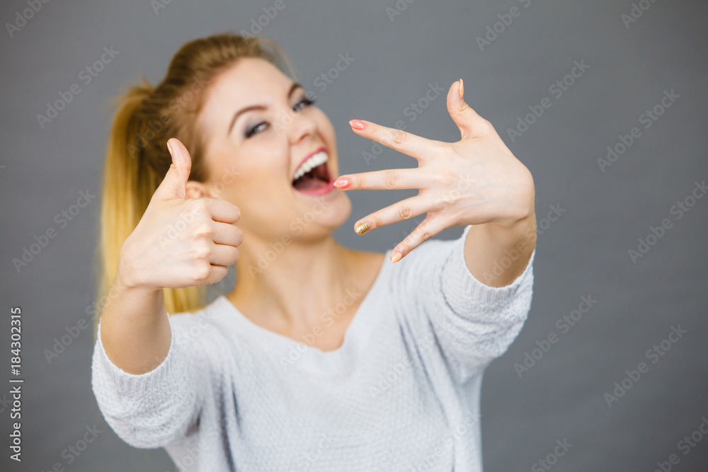 Happy woman showing her hand and thumb up Happy woman showing her hand and thumb up