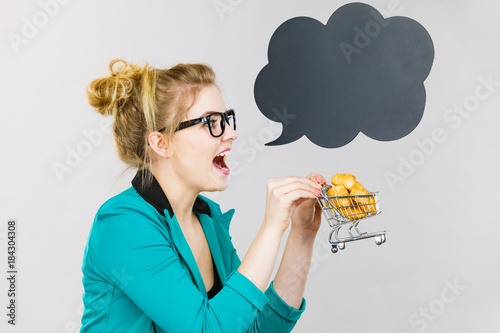 Bussines woman holding shopping cart with sweet bun
