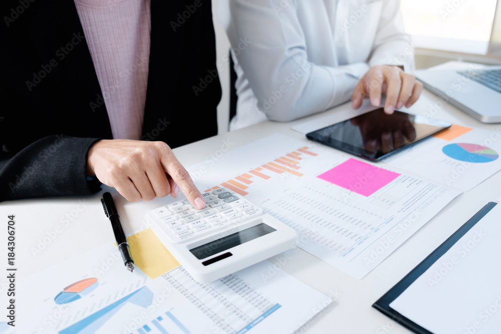 Business colleagues analysis data document with accountant using calculator Business colleagues analysis data document with accountant using calculator