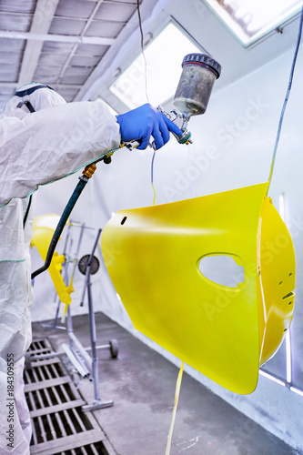 Staining of the car's parts in yellow on the service. photo