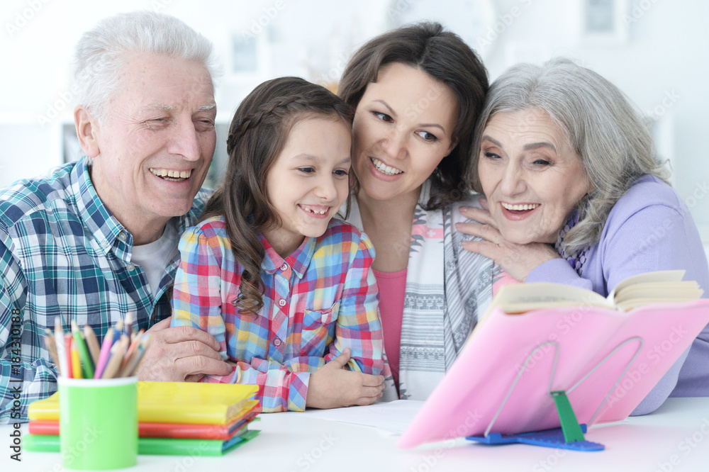 Big family with cute little girl doing homework Big family with cute little girl doing homework