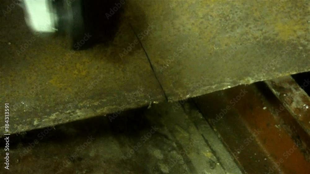 man sawing metal by grinder,working environment. man sawing metal by grinder,working environment.