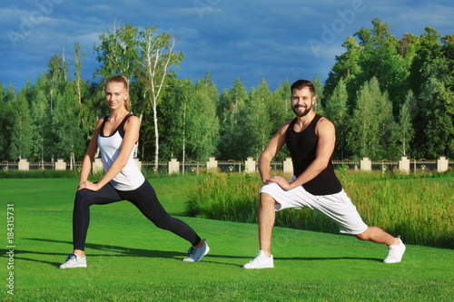 Young sporty couple doing e...