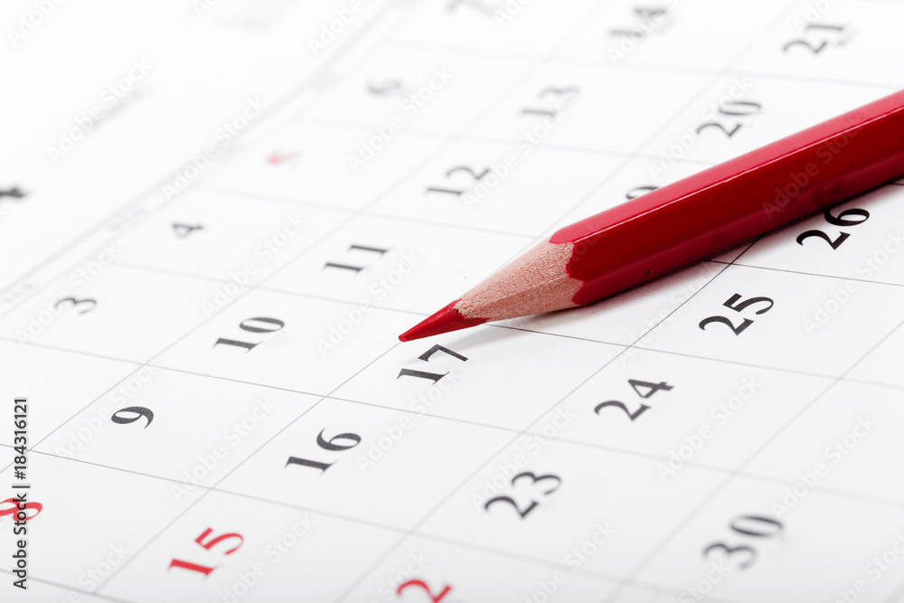 Check out the dates in a business calendar concept Check out the dates in a business calendar concept