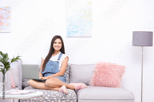 Young woman with laptop at ...