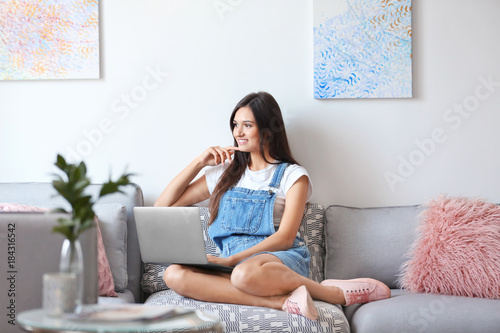 Young woman with laptop at ...
