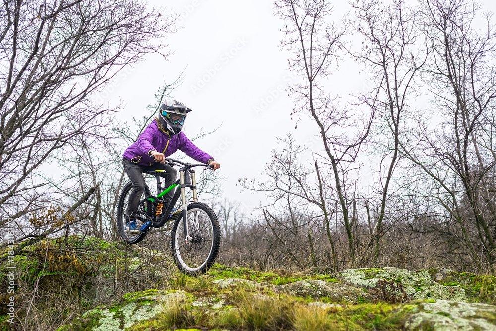 Enduro Cyclist Riding the Mountain Bike on the Rocky Trail. Enduro Cyclist Riding the Mountain Bike on the Rocky Trail.