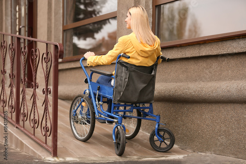 Woman in wheelchair on ramp...