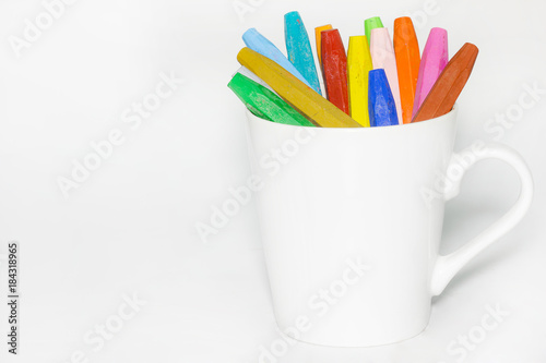 Color Crayons In A glass on white background.